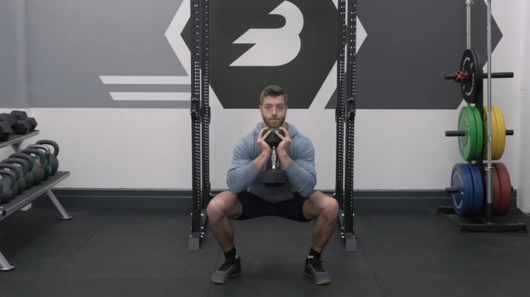 Man front squatting