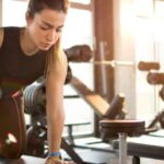 woman performs dumbbell row